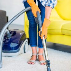 close-up-woman-s-hand-cleaning-carpet-with-vacuum-cleaner