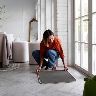 full-shot-woman-decorating-front-door