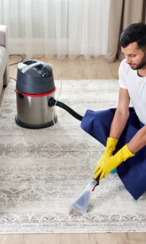 Close-up Of A Person Cleaning Carpet With Vacuum Cleaner Close-up Of A Person Cleaning Carpet With Vacuum Cleaner