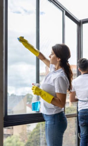 myphoto-1417833215 Team of professional Latin American cleaners cleaning the windows of an apartment - housework concepts