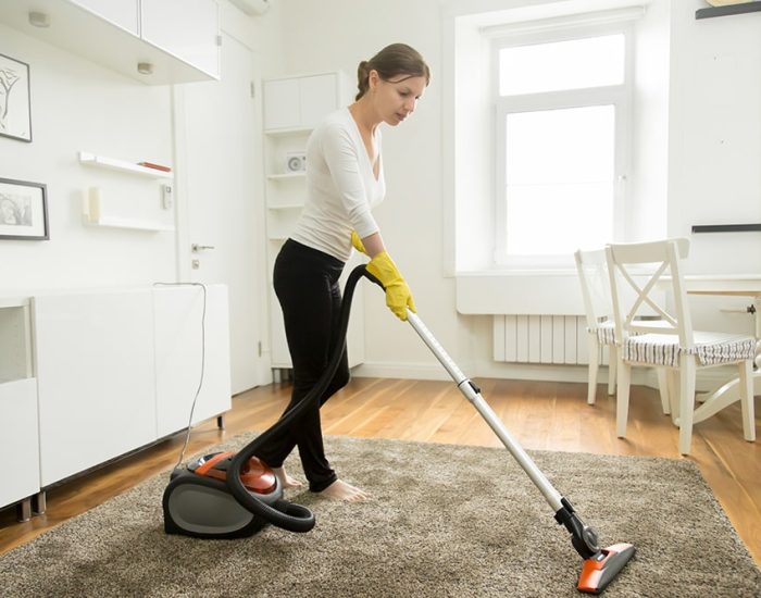 woman-casual-wear-vacuum-cleaning-carpet